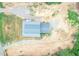 Aerial shot reveals the house's metal roof, sprawling lot, and proximity to wooded areas at 468 Loftis Loop Rd, Roxboro, NC 27574