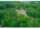 Idyllic aerial view of a house surrounded by dense trees and natural landscape at 468 Loftis Loop Rd, Roxboro, NC 27574