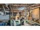 View of a spacious basement featuring an extensive wood working shop with equipment and lighting at 468 Loftis Loop Rd, Roxboro, NC 27574