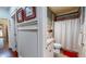 Well-lit bathroom with a granite countertop vanity and a shower with white curtain at 468 Loftis Loop Rd, Roxboro, NC 27574