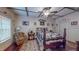 Cozy bedroom featuring wood floors, paneled walls, and a floral bedspread at 468 Loftis Loop Rd, Roxboro, NC 27574