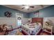 Relaxing bedroom with blue walls, paneled walls, wood floors, and a colorful quilt at 468 Loftis Loop Rd, Roxboro, NC 27574