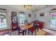 Bright dining area with hardwood floors, wainscoting, a stained glass chandelier and natural light at 468 Loftis Loop Rd, Roxboro, NC 27574