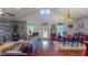 Open-concept living and dining area with hardwood floors, stone fireplace, and vaulted ceilings at 468 Loftis Loop Rd, Roxboro, NC 27574