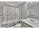 Bathroom with gray vanity and shower/tub with decorative shower curtain at 503 N Sellers St, Selma, NC 27576