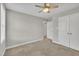 Cozy bedroom with neutral walls, plush carpeting, and a ceiling fan at 503 N Sellers St, Selma, NC 27576