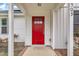 Close-up of the vibrant red front door featuring modern hardware and a covered porch at 503 N Sellers St, Selma, NC 27576