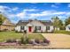 Charming home with a red front door, solar panels, and landscaped front yard at 503 N Sellers St, Selma, NC 27576