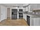 Spacious kitchen with stainless appliances, granite countertops, white cabinets and wood-look floors at 503 N Sellers St, Selma, NC 27576