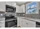 Close-up of kitchen featuring stainless steel appliances, granite countertops and tile backsplash at 503 N Sellers St, Selma, NC 27576