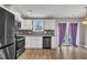 Bright kitchen with stainless appliances, white cabinets, gray backsplash and granite countertops at 503 N Sellers St, Selma, NC 27576