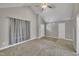 Inviting living room with neutral walls, vaulted ceiling, large window, and plush carpeting at 503 N Sellers St, Selma, NC 27576
