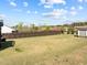 Large, grassy backyard enclosed by a wooden fence offers privacy and space for activities at 508 Moore Hill Way, Holly Springs, NC 27540