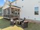 The backyard features an outdoor lounge space, firepit, and screened in porch at 508 Moore Hill Way, Holly Springs, NC 27540