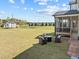 The backyard includes an outdoor lounge space and green space at 508 Moore Hill Way, Holly Springs, NC 27540