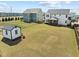 Aerial view of a large backyard with patio, outdoor shed, and green space at 508 Moore Hill Way, Holly Springs, NC 27540