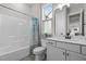 This bright bathroom has a modern vanity and shower-tub combination at 508 Moore Hill Way, Holly Springs, NC 27540