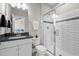 Well-lit bathroom featuring a glass enclosed shower, granite vanity and modern finishes at 508 Moore Hill Way, Holly Springs, NC 27540
