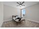 Comfortable bedroom features carpet, ceiling fan, and a large window with neighborhood views at 508 Moore Hill Way, Holly Springs, NC 27540