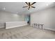 Spacious bonus room features neutral walls, carpet, ceiling fan and built in storage at 508 Moore Hill Way, Holly Springs, NC 27540