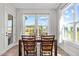 Bright dining room features backyard views through large windows with natural light at 508 Moore Hill Way, Holly Springs, NC 27540