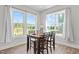 Cozy dining area features natural light and backyard views through large windows at 508 Moore Hill Way, Holly Springs, NC 27540