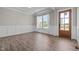 Welcoming entryway featuring hardwood floors, wainscoting, and a stylish wooden door at 508 Moore Hill Way, Holly Springs, NC 27540