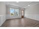Welcoming entryway featuring hardwood floors, wainscoting, and a stylish wooden door at 508 Moore Hill Way, Holly Springs, NC 27540