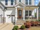 Inviting front porch with stone steps, classic rocking chairs, and tasteful landscaping at 508 Moore Hill Way, Holly Springs, NC 27540