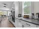 Modern kitchen boasts sleek white cabinets, dark countertops, and stainless steel appliances at 508 Moore Hill Way, Holly Springs, NC 27540