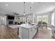 Open-concept kitchen island with modern appliances and seamless connection to the living space at 508 Moore Hill Way, Holly Springs, NC 27540