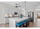 Bright kitchen with island seating, stainless appliances, and modern pendant lighting at 508 Moore Hill Way, Holly Springs, NC 27540