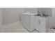 Well-maintained laundry room with washer, dryer, and utility sink with storage at 508 Moore Hill Way, Holly Springs, NC 27540