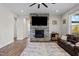 Cozy living room featuring a stone fireplace, large TV, and comfortable seating at 508 Moore Hill Way, Holly Springs, NC 27540