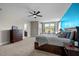 Spacious main bedroom with sitting area, and en-suite bath, with plush furnishings and ceiling fan at 508 Moore Hill Way, Holly Springs, NC 27540