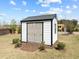 A well-maintained white shed provides extra storage space on the property at 508 Moore Hill Way, Holly Springs, NC 27540