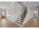 Open staircase with wood treads and modern railing at 508 Moore Hill Way, Holly Springs, NC 27540