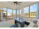 This sunroom features an outdoor dining and lounge space with a ceiling fan at 508 Moore Hill Way, Holly Springs, NC 27540