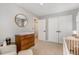 Bright Bedroom featuring a dark-wood dresser and a neutral-toned chair and ottoman at 7708 Foxwood Dr, Raleigh, NC 27615