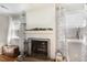 Bright living room showcasing a white-painted brick fireplace with elegant decor and windows at 7708 Foxwood Dr, Raleigh, NC 27615