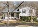 Charming exterior with inviting front porch with chairs and well-maintained landscaping at 7708 Foxwood Dr, Raleigh, NC 27615