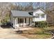 Charming exterior with inviting front porch with chairs and well-maintained landscaping at 7708 Foxwood Dr, Raleigh, NC 27615