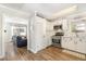 Bright kitchen featuring white cabinets, stainless steel appliances, and hardwood floors at 7708 Foxwood Dr, Raleigh, NC 27615
