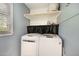Laundry room featuring front loading washing machine and dryer with shelf at 7708 Foxwood Dr, Raleigh, NC 27615