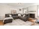 Cozy living room with a comfortable sectional sofa, fireplace, and natural light at 7708 Foxwood Dr, Raleigh, NC 27615