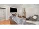 Inviting living room featuring a comfortable gray sofa, mounted TV, and hardwood floors at 7708 Foxwood Dr, Raleigh, NC 27615