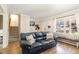 Cozy living room featuring a blue leather sofa, hardwood floors, and a window bench at 7708 Foxwood Dr, Raleigh, NC 27615