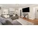 Comfortable living room with large sectional sofa, painted brick fireplace, and a flat screen TV at 7708 Foxwood Dr, Raleigh, NC 27615