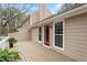 View of large deck with red door and siding with an area for dining at 7825 Breckon Way, Raleigh, NC 27615