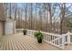 The large deck features white railings and peaceful view of a wooded area at 7825 Breckon Way, Raleigh, NC 27615